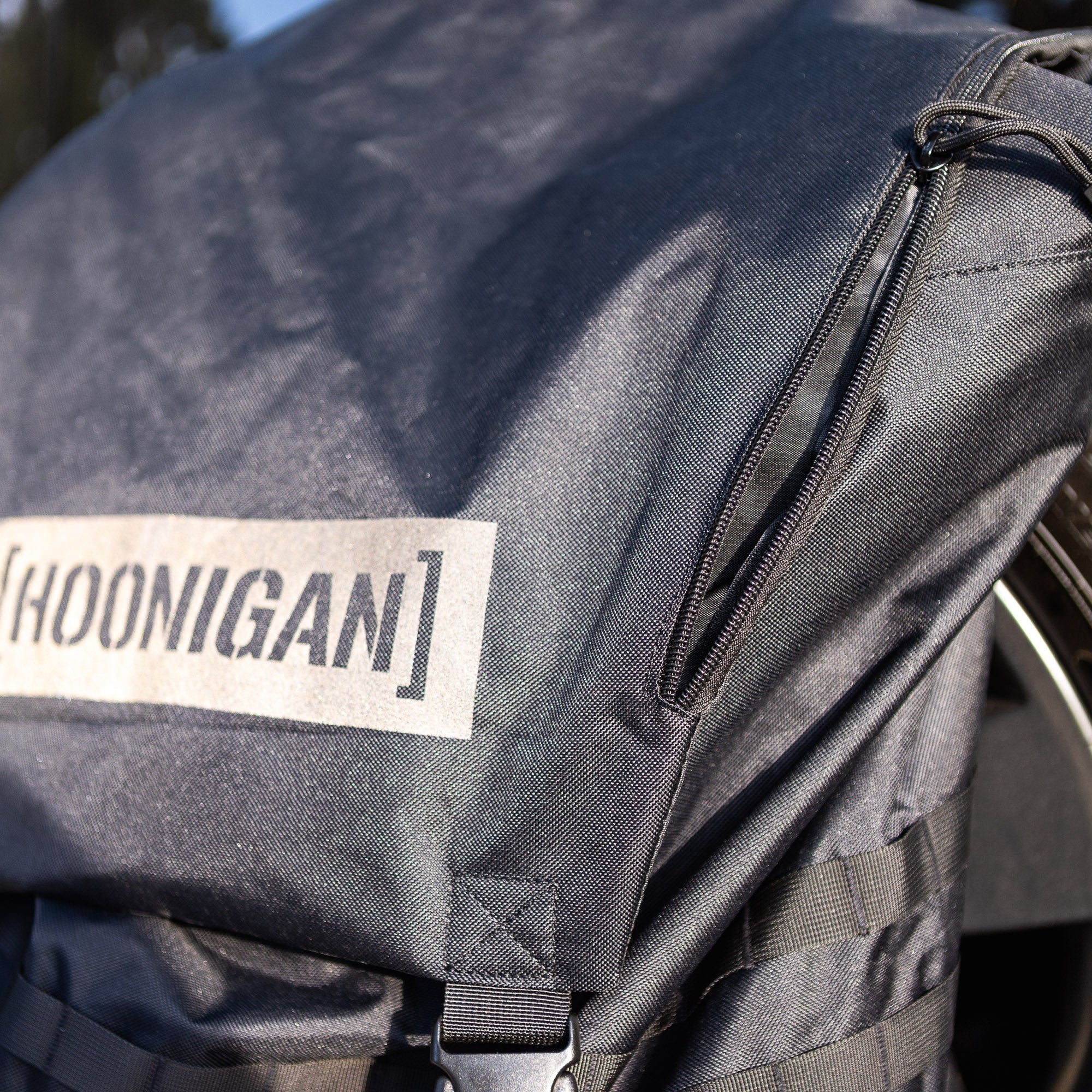 Hoonigan CENSOR BAR spare tire backpack featuring durable fabric and adjustable straps for automotive enthusiasts.