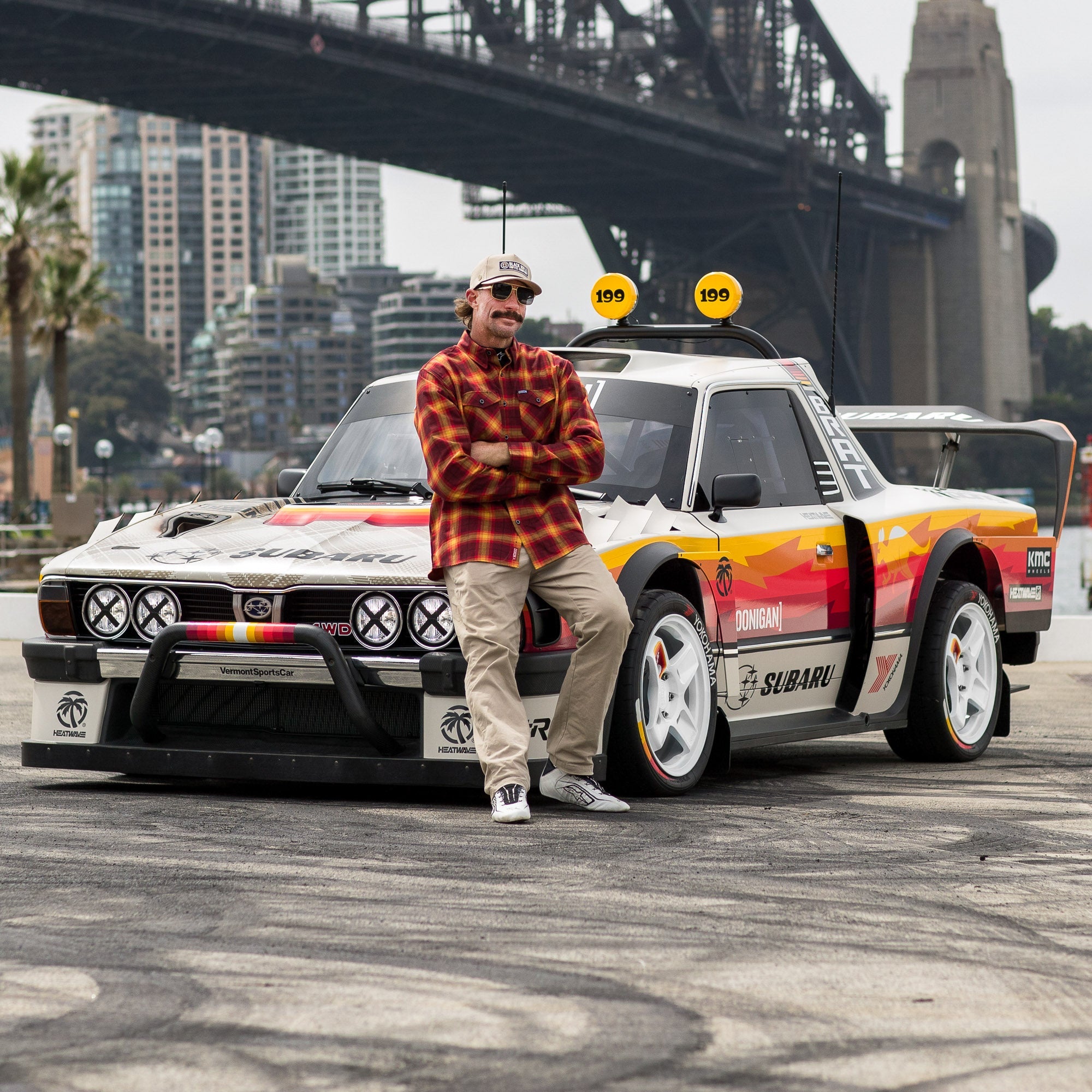 Hoonigan x Leen Customs GYMKHANA BRAT collectible pin featuring a classic rally car and a motorsport enthusiast.